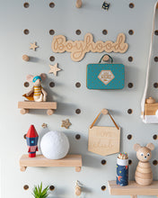 Load image into Gallery viewer, boyhood wall wall sign on a light blue peg board