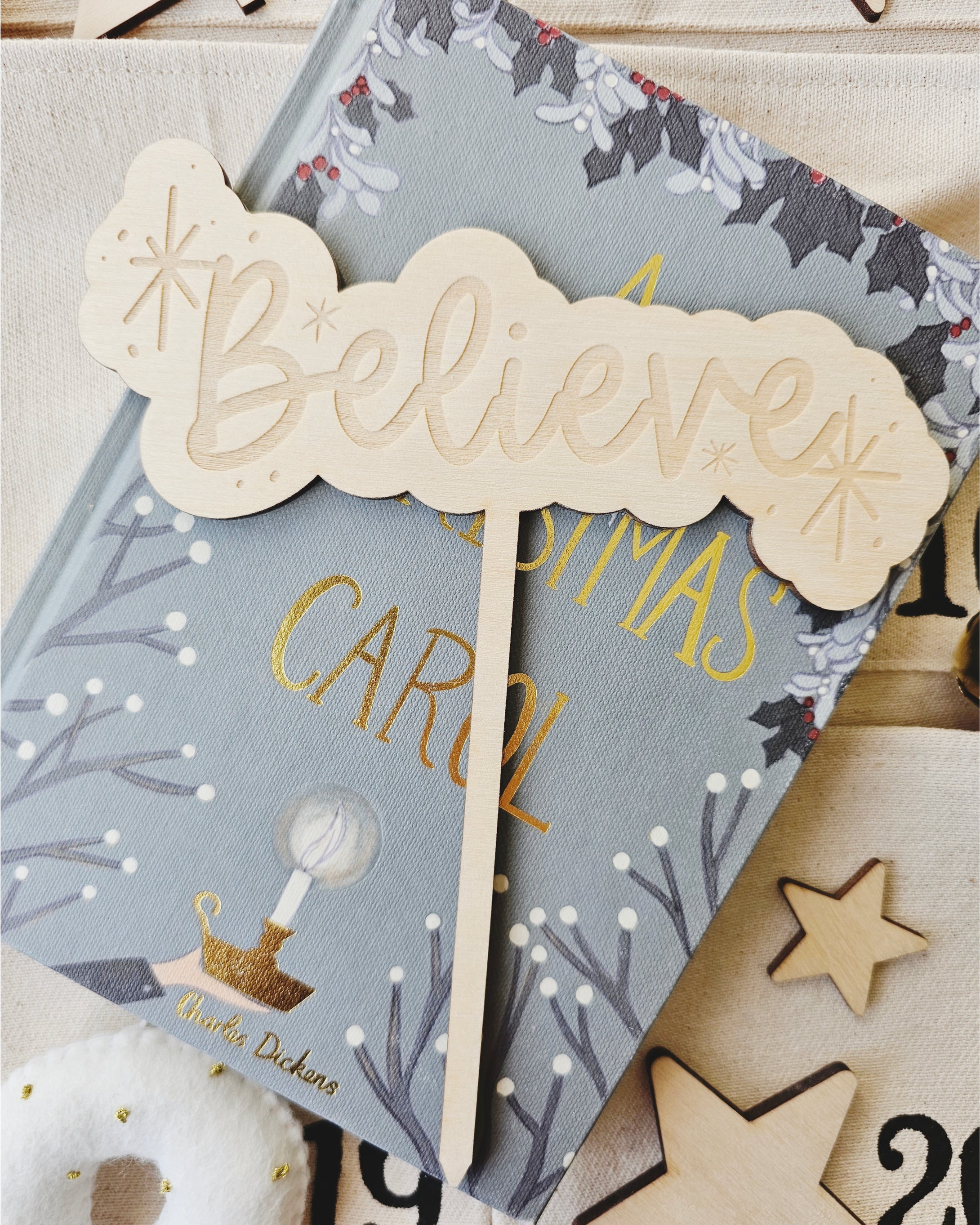 Wooden believe cake topper with hand drawn simple star detail