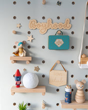 Load image into Gallery viewer, boyhood wall wall sign on a light blue peg board
